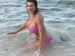 Topless brunette MILF in pink bikini plays in ocean waves outdoors & takes shower