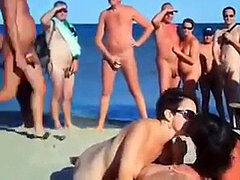 four mates have fuckfest on bare beach in front of crowd