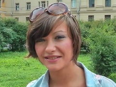 A brunette shows her natural tits and puffy nipples outside