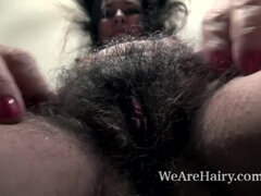 Kelly Lima strips naked on her brown couch