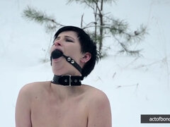 Naked barefoot Claudia chained in the snow
