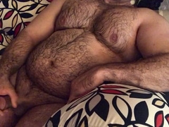Hairy man lounging on the couch