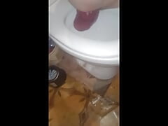 A huge anal prolapse fell out from a young guy sitting on the toilet and a big bottle in his ass standing by the bathroom mirror