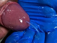 This horny guy jerks his cock with a latex glove until he unloads wonderfully