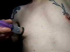 syringe suction nipple , man with piercings and tattoos