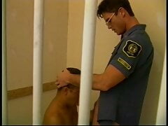 Prisoner is behind bars while blowing officer's dick