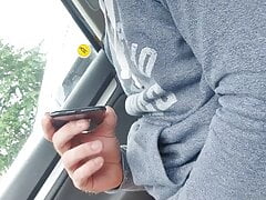 Muscular guy has fun in a car public place watching porno