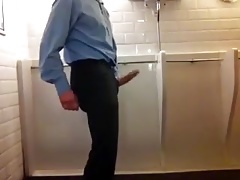 A suited wanker in a public bathroom
