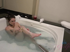 After you finger her, Nina takes a bubble bath.