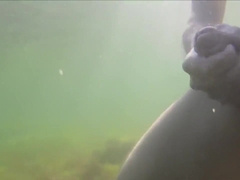underwater cumshot / underwater action / on a public beach / nude swimming
