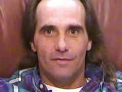 Long-haired dude with a furry stomach has got a giant boner