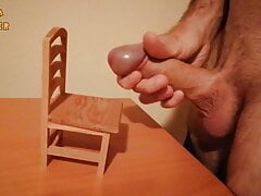 Handjob and cumshot on a small wooden chair