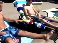 Twink gets spitroasted by two young studs by the pool