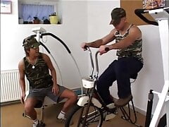 Gay bottom sits on bike and takes cock up his ass