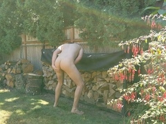 Sexy young stud pleasures himself in the backyard, fingering his tight hole before shooting his load on the grass