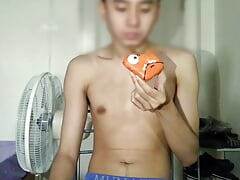 A teenage boy enjoys masturbation and eating donuts at the same time.