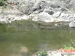 Teen gay swimmer playfully going down in the river