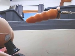 Caged twink in pink spandex enjoys machine and fisting action