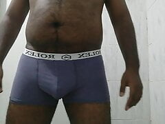 An Asian black boy pissing in his underwear