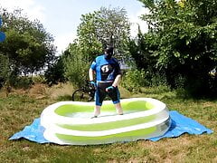 Cyclist pup in pool - cooling down and pawing off