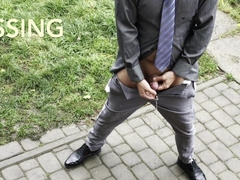 Suited fellow in socks and truss with a fake penis