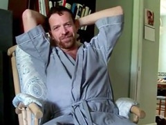 Hairy artist bathrobe highlights by a fan