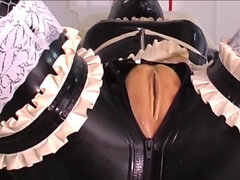 One girl is bound in latex as the other one strap-on fucks her
