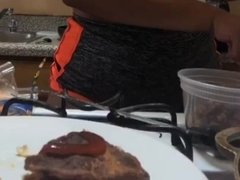 Busty young black girl is making food in kitchen and shaking tits
