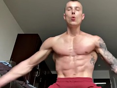 Ripped tattooed jock cums in indoor solo action
