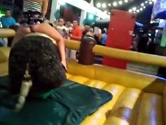 Girls riding mechanical bull