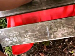 Red skirted girl rides her guy to creampie in public park