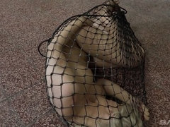 Rebecca Black is fucked with a dildo through a net enclosure