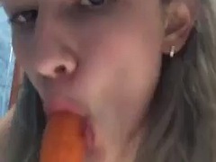 The sexy KrisWater masturbates with a carrot