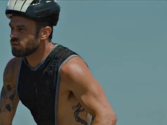 Handsome guy fucks a sports biker in the middle of a field
