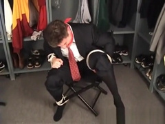 Suited coach tied to chair and cleave gagged in the locker room