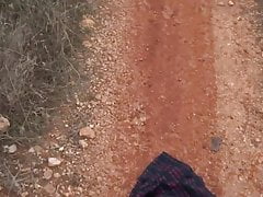 red tartan skirt getting kicked on dirt road and mud puddles