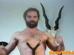 Hairy gay man strokes his fat cock in fetish retro clip