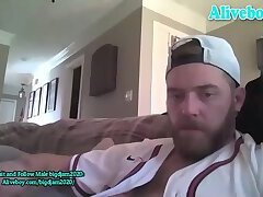bearded guy masturbates on the sofa