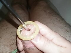 Rolling condom into urethra, urethral sounding, Close Up