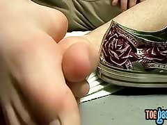 Austin Lucas plays with his feet and cock in a storage room