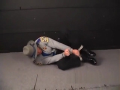 Cop pigtied and ball gagged.