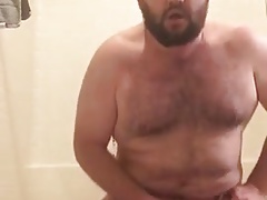 Bear jerks off while he ducks his dildo