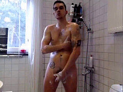 beautiful young man takes douche