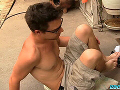 Nerdy youngster Zack Randall with glasses stroking it outdoor