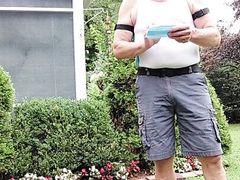 Daddy gardener doing yard work and hosing off