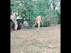 Nude boy walking in forest having fun