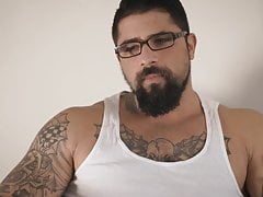 Ryan's cock is rock-hard as he stretches his balls