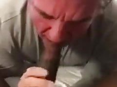 Old daddy giving a deep blowjob to a big black cock