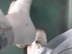 a young dude in blue denim sneakers and white socks jacks off on an empty teach in Milan