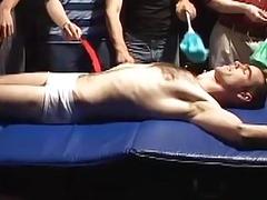 Restrained amateur laughs during foot and body tickling